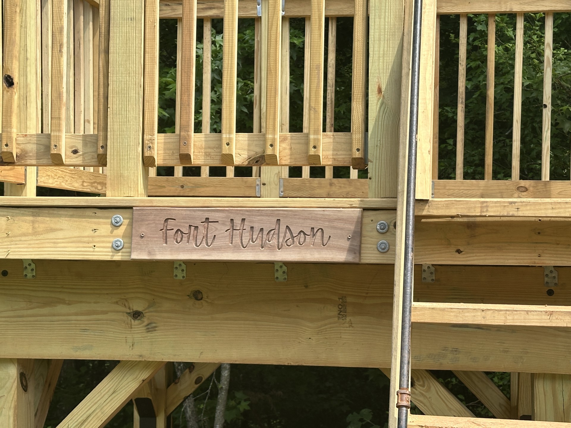 Fort Hudson name burned into the deck beam of a finished backyard fort