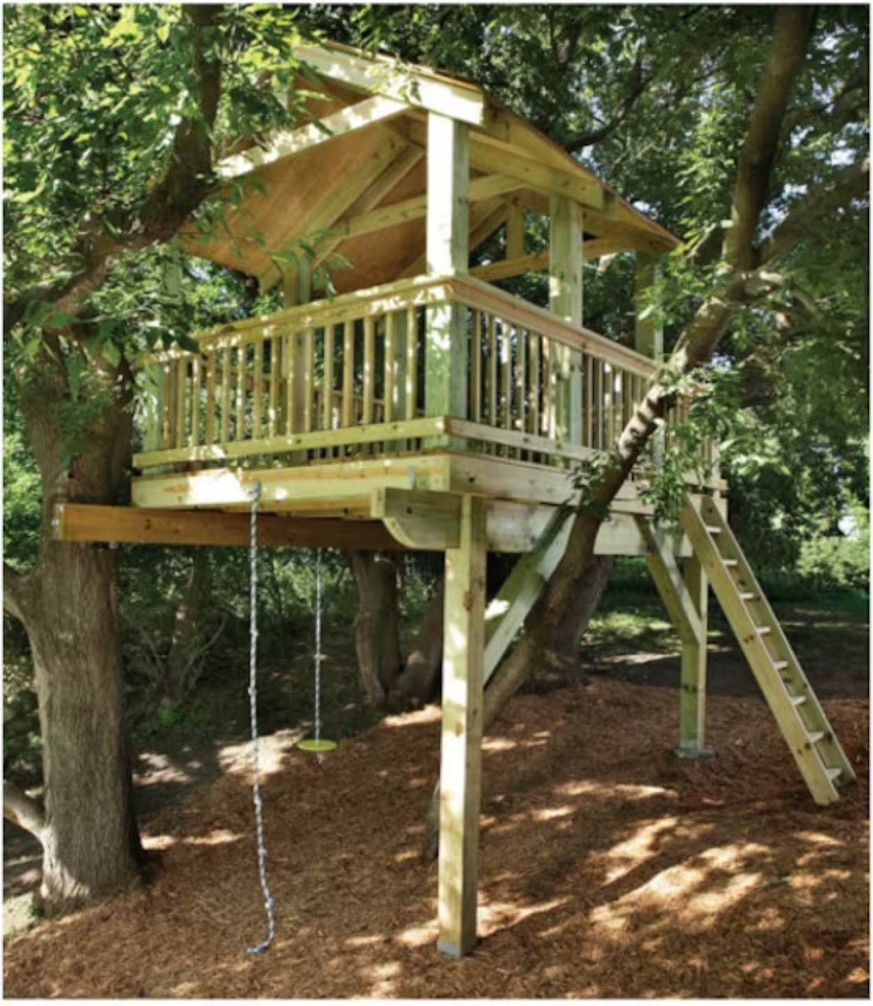 Backyard playhouse with swings in a shaded yard